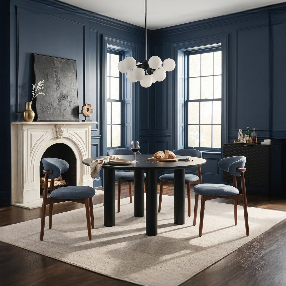 Blue dining chairs around a round black table